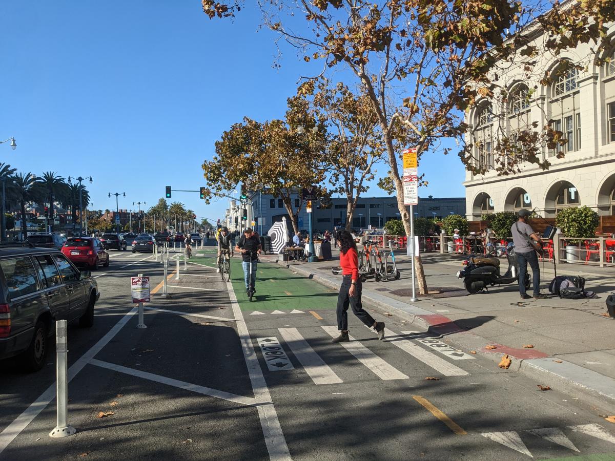 Pedestrian shown using a crosswalk at an intersection