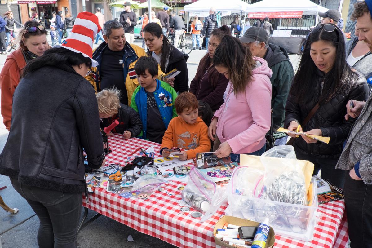 A street vendor interacting with event goers at Sunday Streets in the Excelsior District on March 25, 2018