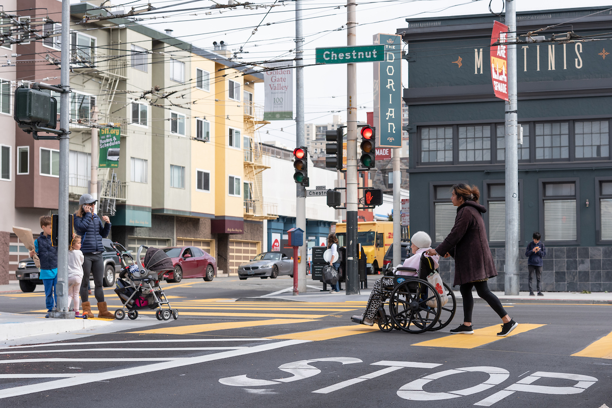 woman pushing a woman in a wheelchair on Chestnut Street