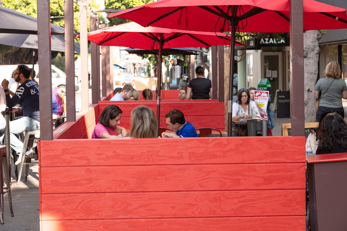 People dining in an outdoor enclsoure.