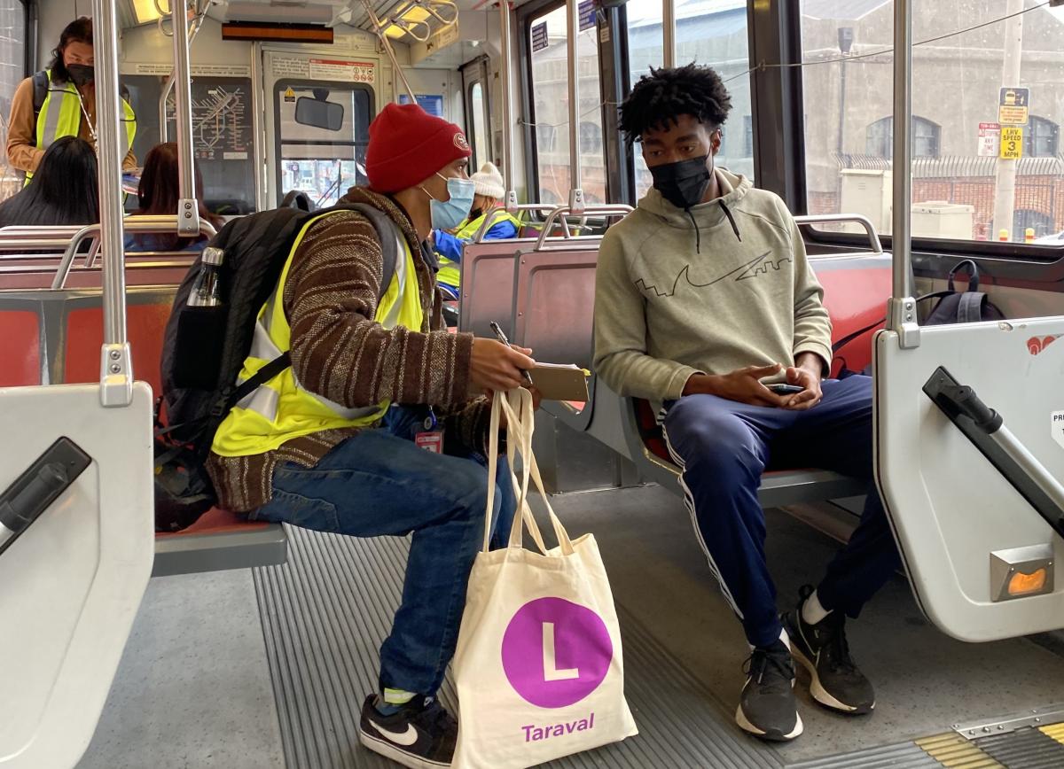 An M Ocean View rider talks to a SFMTA staff member about their experiences riding the line.