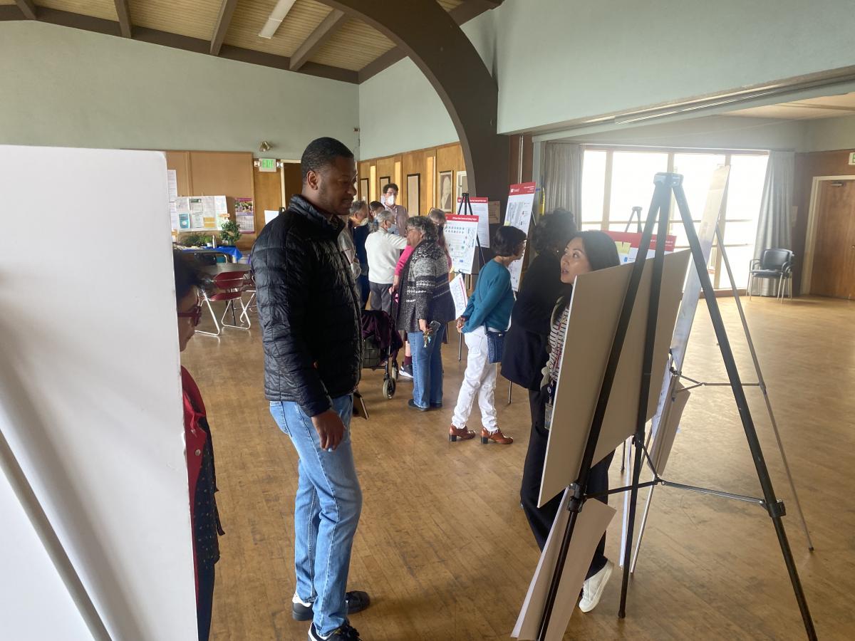 Community members view posters and talk to staff at our May 9 open house. 