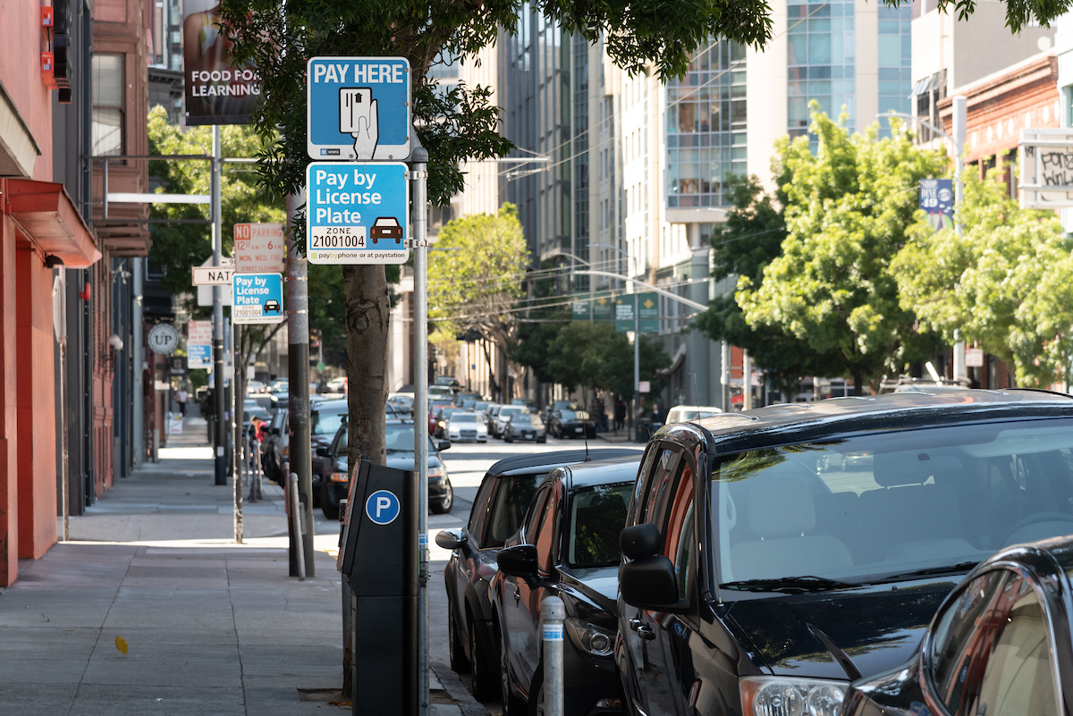 A Pay by License Plate system in San Francisco on a street with cars and trees.