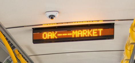 A destination sign inside a Muni bus showing the upcoming stop at Oak and Market