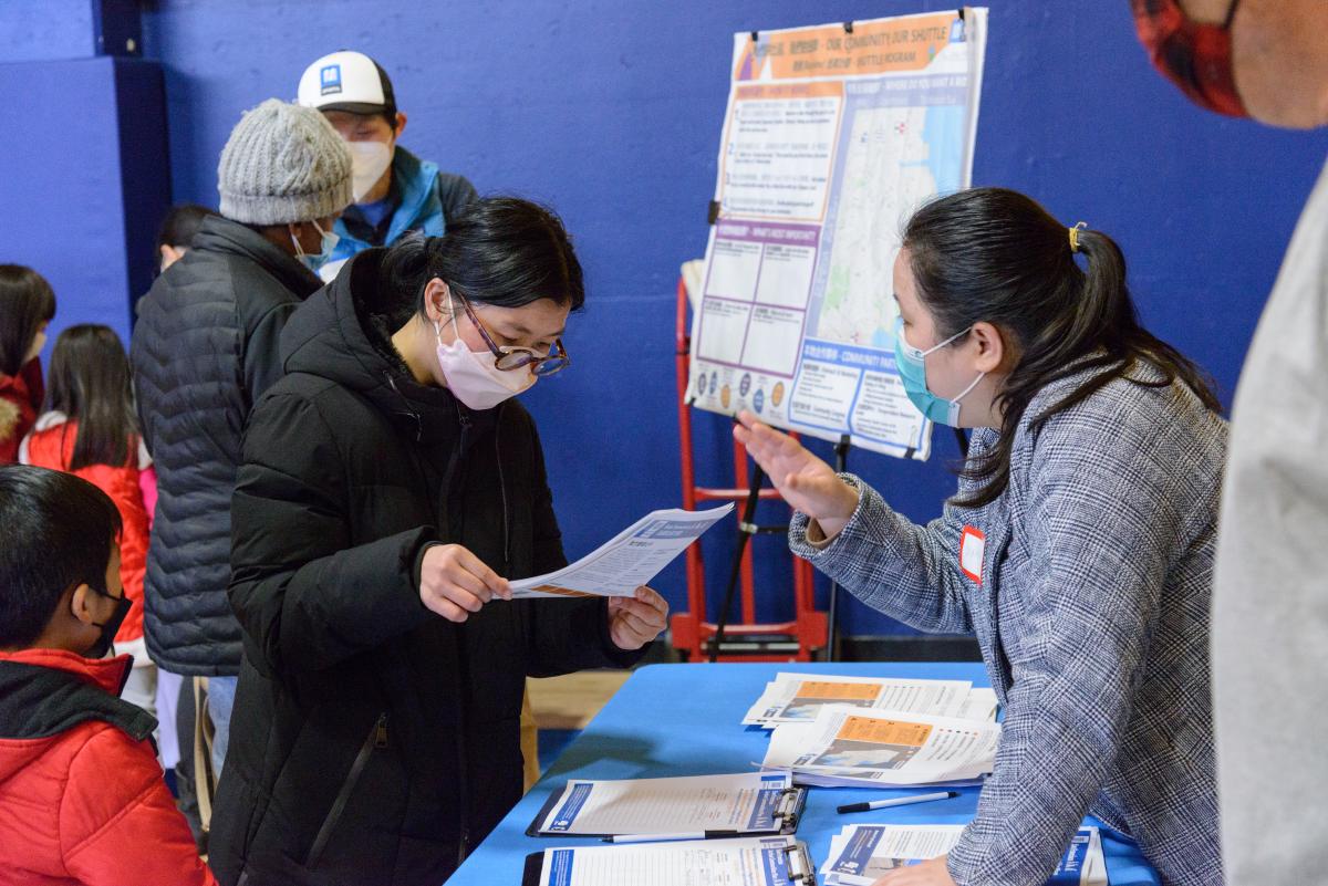 Participants in the Bayview Black History month and Lunar New Year celebration stop by a table to learn about the Active Communities Plan