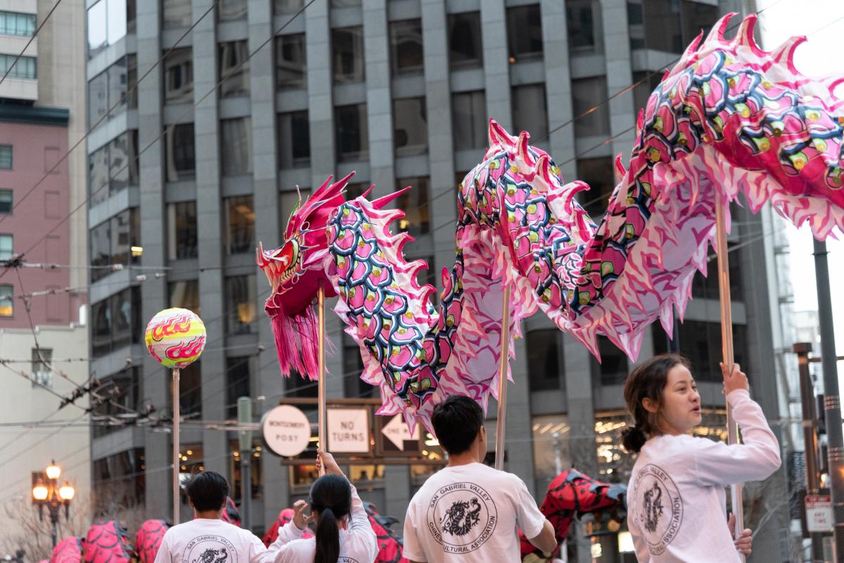 Parade-goers carry a Chinese dragon down a San Francisco street