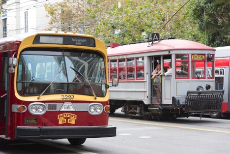 A vintage bus and streetcar next to eachother in San Francisco.