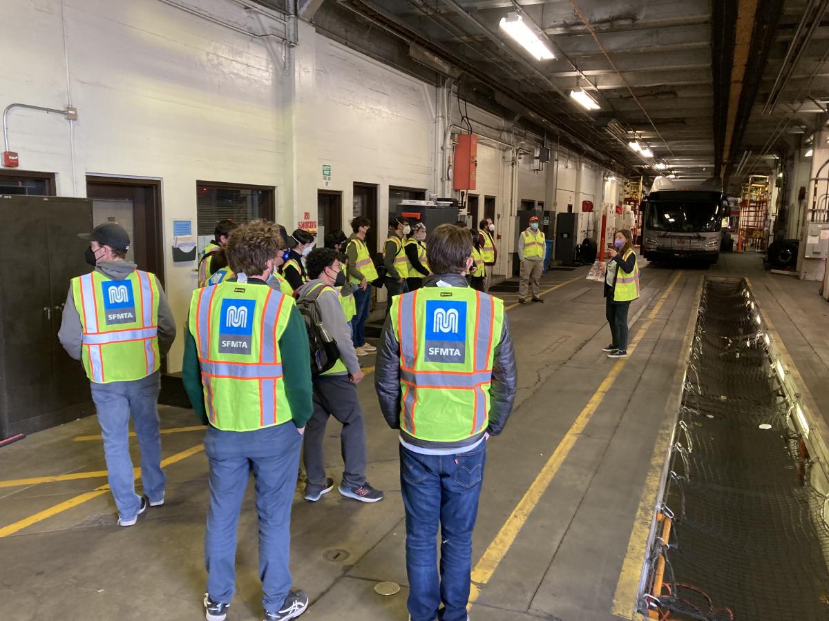 people touring a bus facility