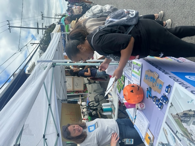 Project team members giving information to a member of the community