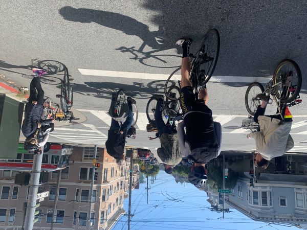 A group of 6 people on bicycles on a street