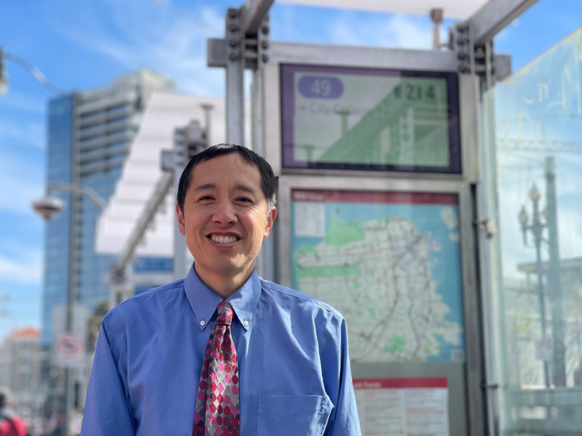 Photo of SFMTA staff Jason Lee in front of a new Customer Information System display.