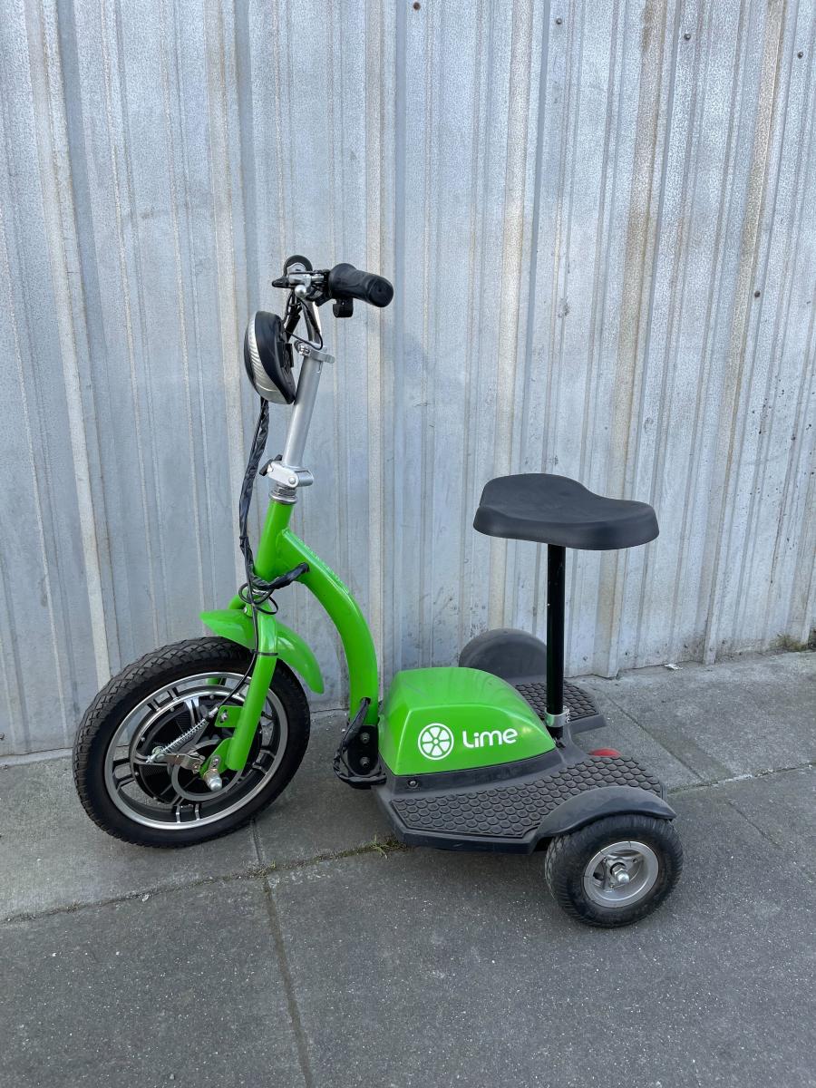 Lime green and black trike with wide footboard and seat