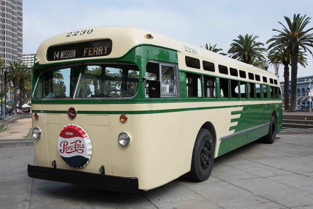 a vintage 1956 Mack motor coach, No. 2230, is shown, fully restored to immaculate condition, wearing its original Wings livery.