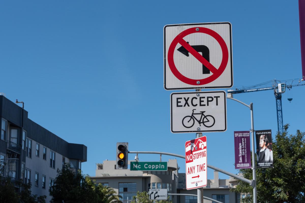 Image of sign that lets drivers know there are no left turns. Sign has a left turning arrow with a red symbol over it signifying that it is illegal.