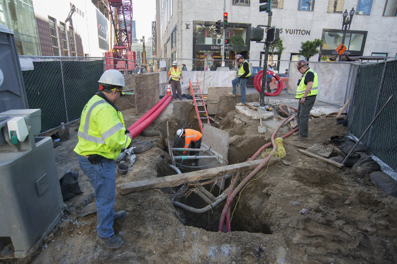 Workers uncover and<br />
    reconfigure utility lines at the corner of Stockton Street and Geary Boulevard.