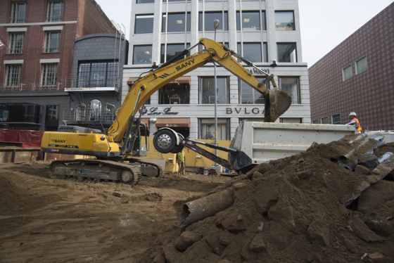 Workers remove material off the site at Stockton and Geary.