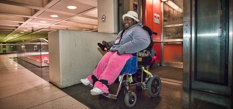 Passenger using an elevator at a Muni Metro Station