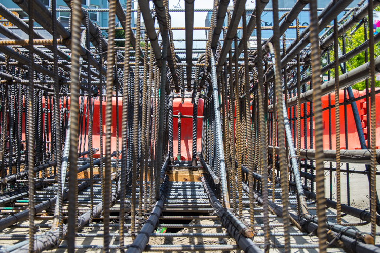 Looking inside one of many steel rebar cages used to reinforce underground station walls. These cages are<br />
    lowered into excavated shafts and concrete is poured.