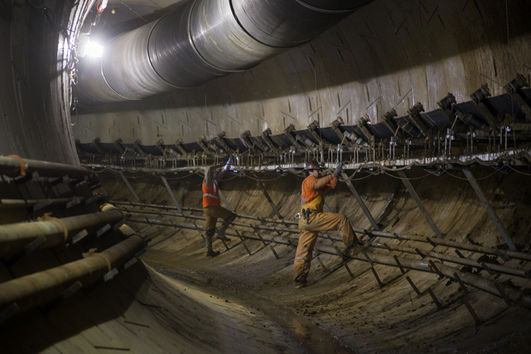 Inside a tunnel, crews work on the conveyor system that transports ground spoils to the underground launch site at 4th and Harrison.