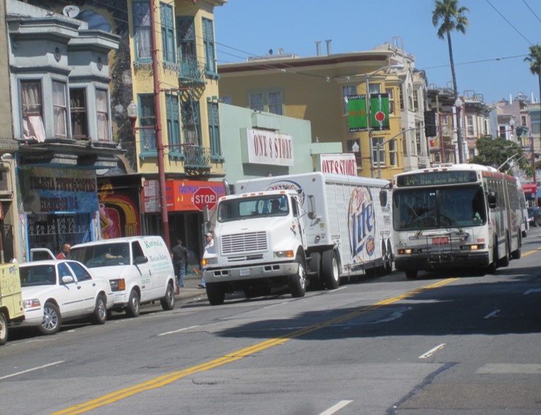 Mission bus straddling double yellow due to narrow lanes