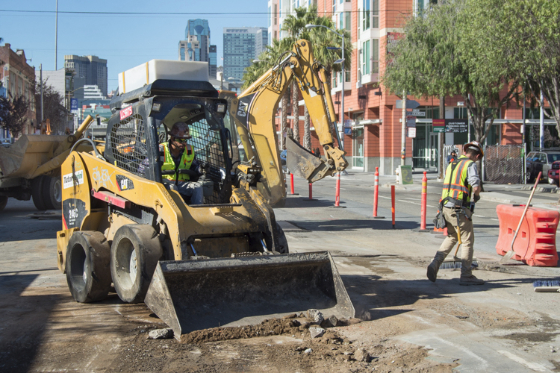 A worker cleans up the roadway on 4th Street.