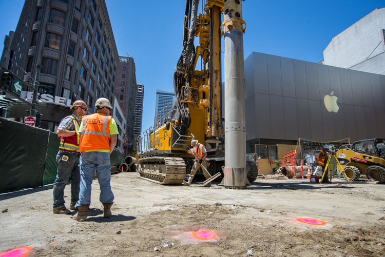 At the corner of Ellis and Stockton, surveyors mark where future underground wall sections will be<br />
    constructed.