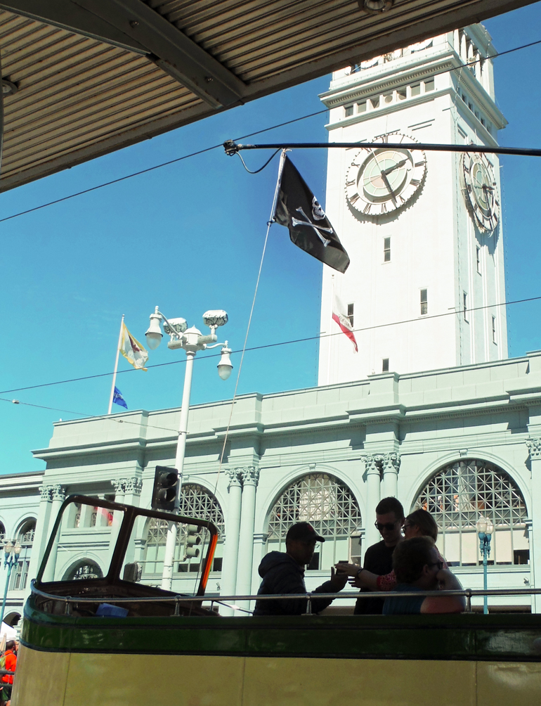 Boat Car 233 flying skull and crossbones pirate flag from trolley pole at Ferry Building, September 26, 2015