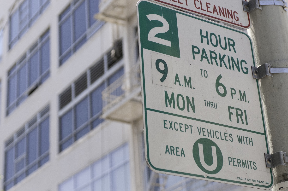 Street sign for two-hour residential parking permit area.