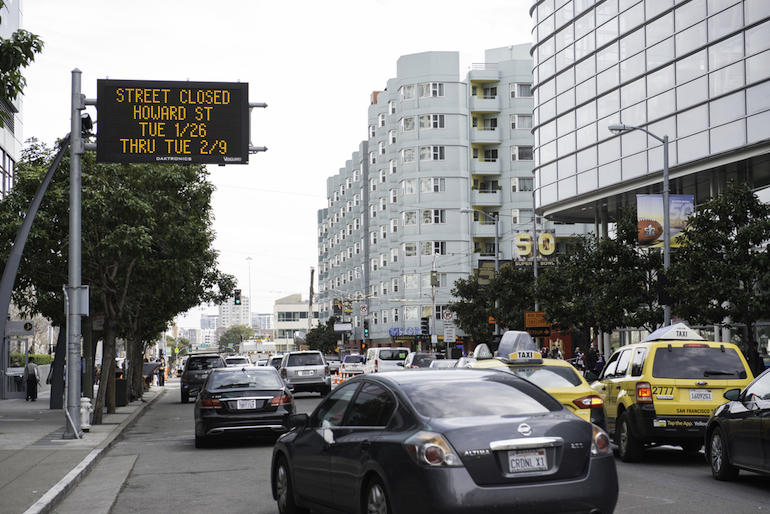 Large electronic sign along 4th Street reads "Street Closed, Howard St, Tue. 1/26, Thru Tue 2/9."