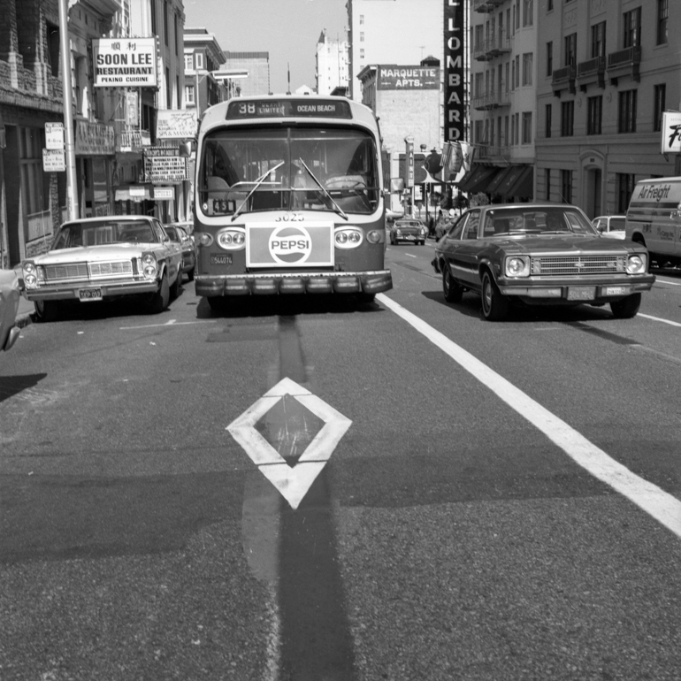 Front view of bus on 38 Geary Line in transit only lane on Geary and Van Ness. April 28, 1978