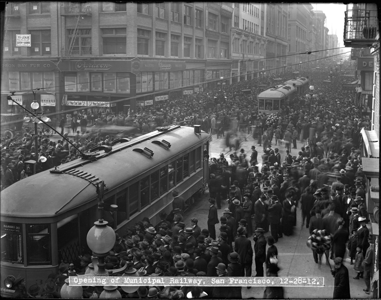 Overhead view of crowds surrounding streetcars on Geary and Grant for opening day of the San fRancisco Municipal Railway | December 28, 1912