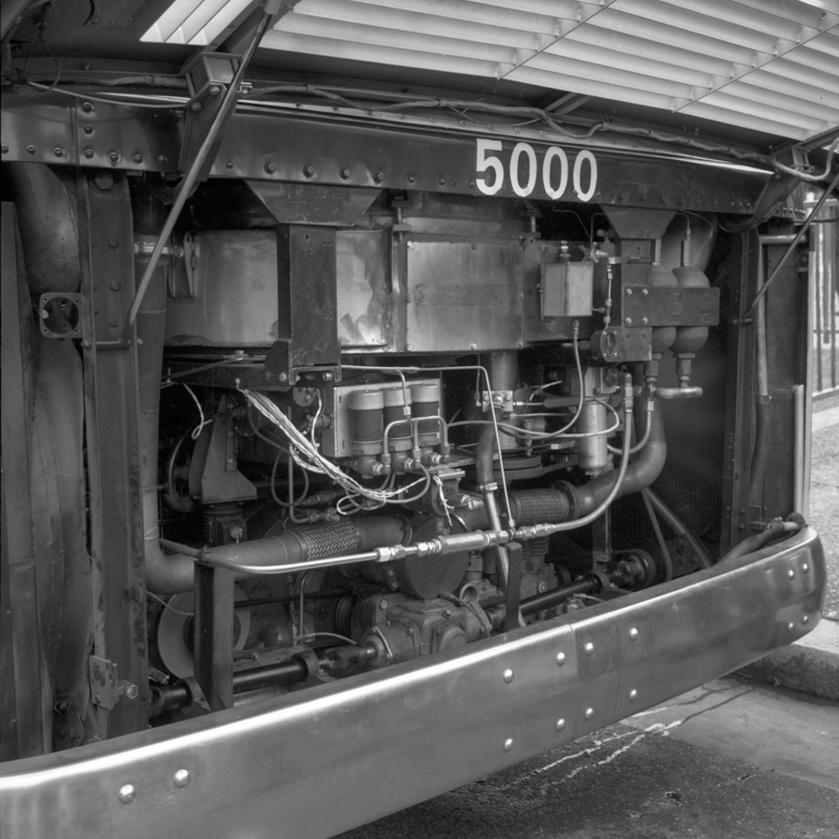 Close-up view of engine compartment on GMC steam bus showing a network of piping, gearboxes, and wiring that makeup the steam turbine of this experimental bus.