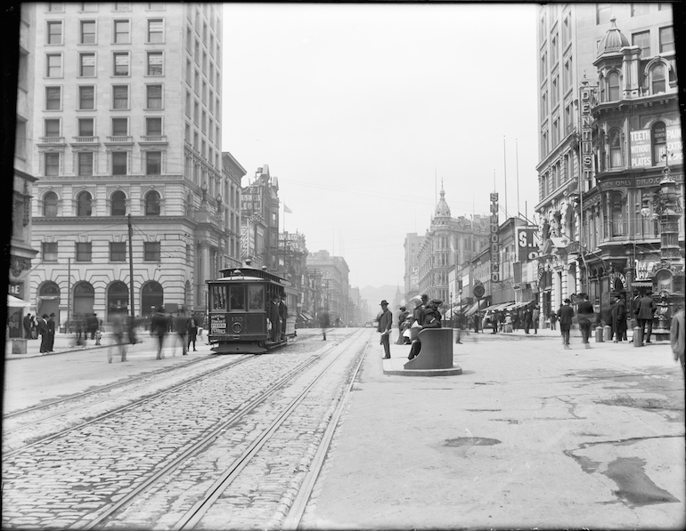 Black and white photo taken January 9, 1906 on Market and 3rd Streets looking west.  At center frame left is a cable car and at frame right is a passenger boarding platform.