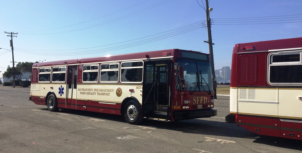Maroon and white buses with emergency ensignia and "San Francisco Fire Department Mass Casualty Transport" on the side.