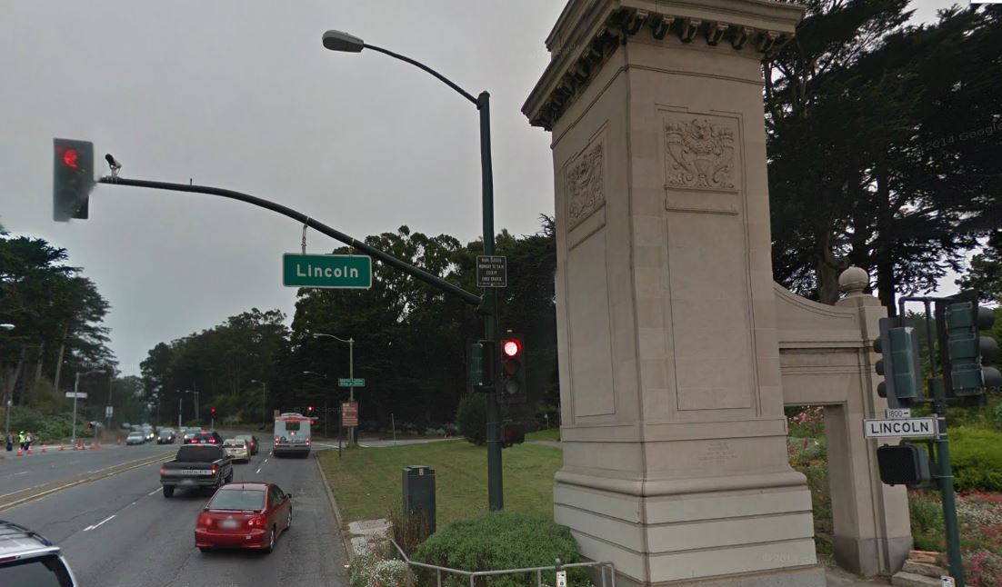 Northbound traffic on 19th Avenue/Crossover Drive at Lincoln Way with a Muni bus in the right lane.