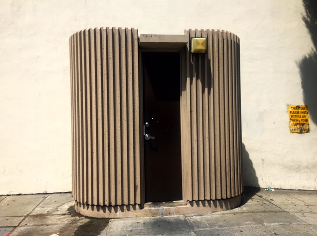 Crenulated, oval beige operator convenience station located at Norh Point and Van Ness Avenue.