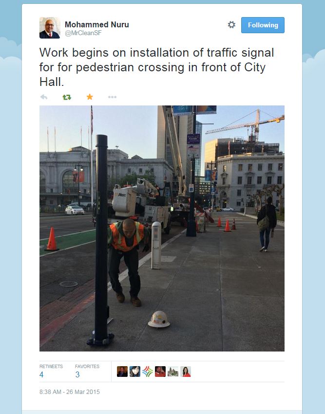 Tweet from Mohammend Nuru, director of SF Public Works, "Work begins on installation of traffic signal for pedestrian crossing in front of City Hall." Photo of man in safety vest and cherry-picker on Polk St. is below.
