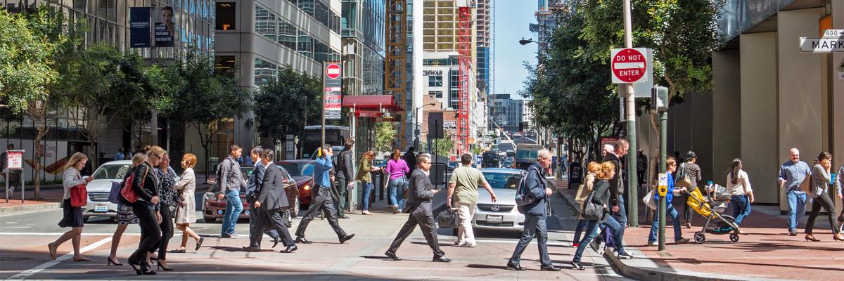 Pedestrians on Market Street crossing in an intersection during afternoon rush house