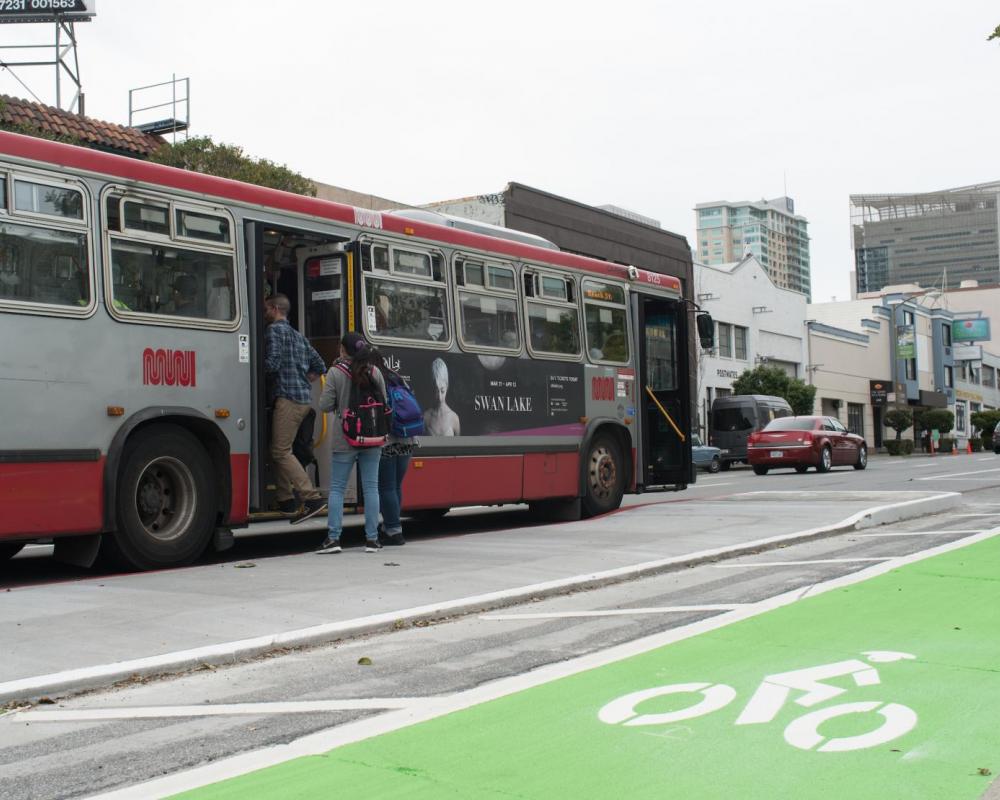 7th Street after: bus riders board Muni bus from a transit boarding island