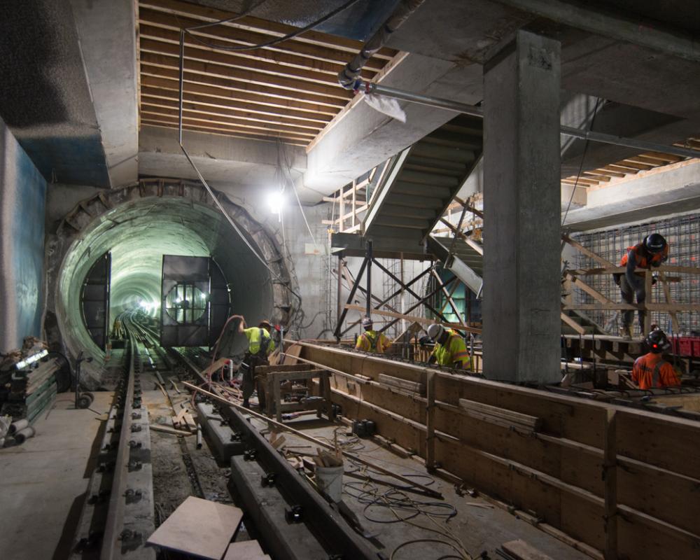 Workers construct final structural elements of the Yerba Buena/Moscone station platform.