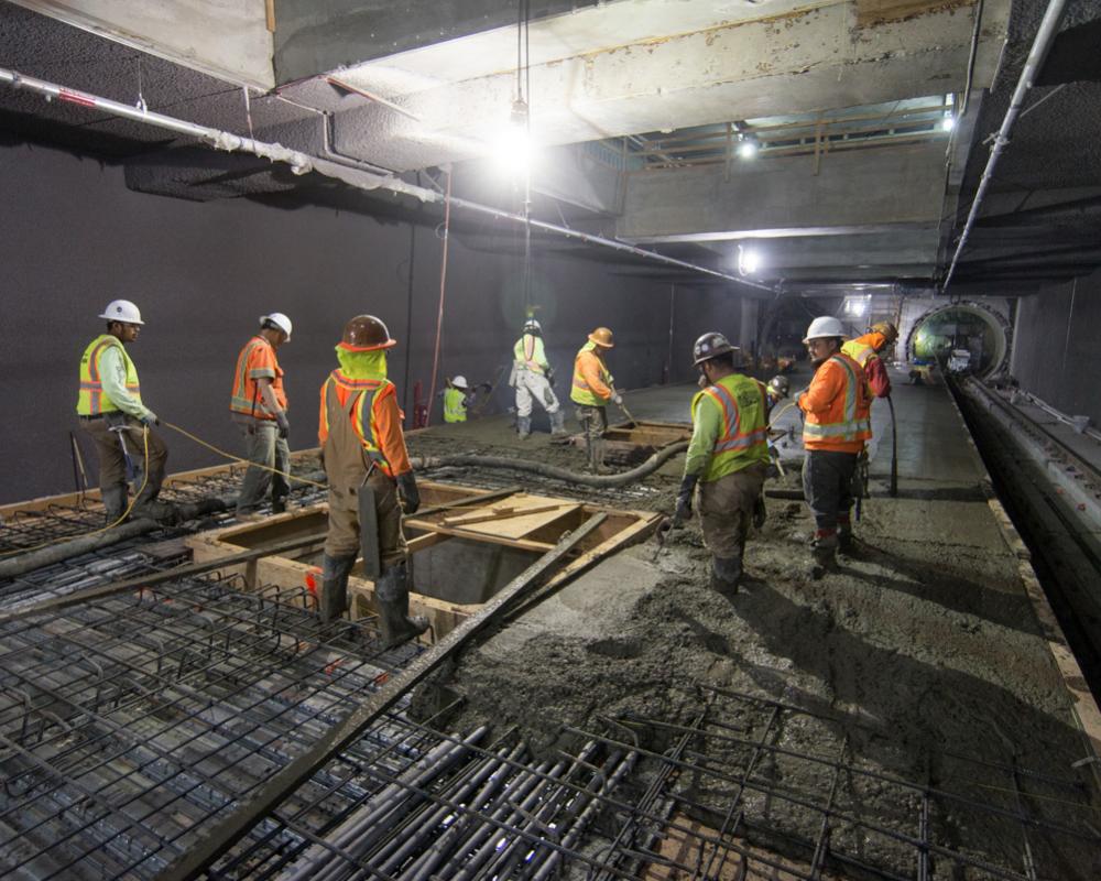 A crew pours concrete around future elevator footings inside the Yerba Buena/Moscone station box.