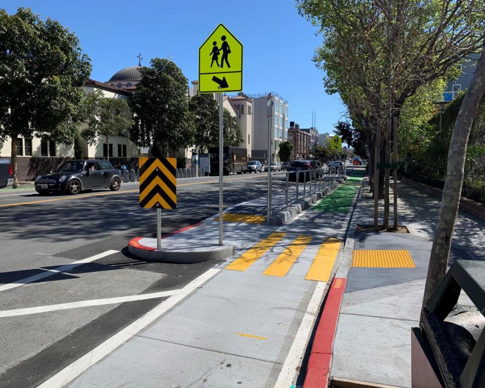 New protected bikeway, including a school loading island on Valencia