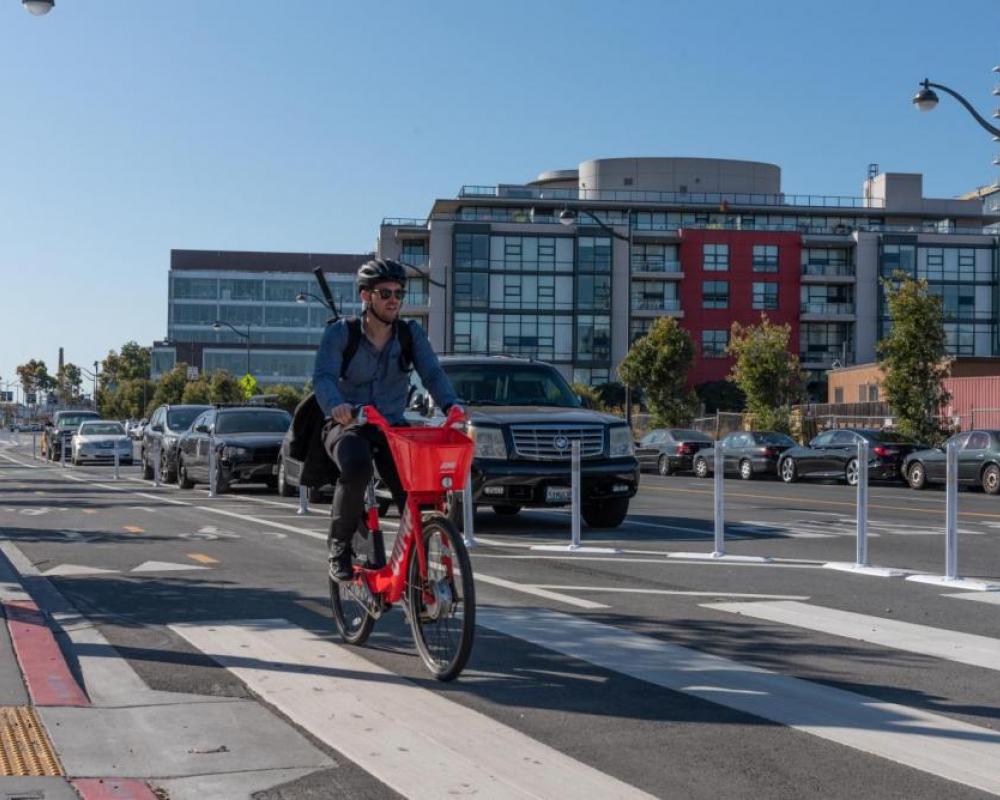 A person riding a JUMP bike on Terry Francois Blvd.