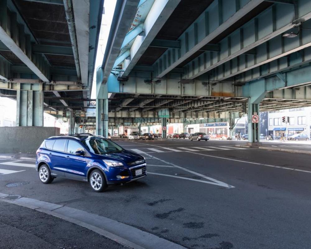 a blue car turning from a slip lane onto 13th Street