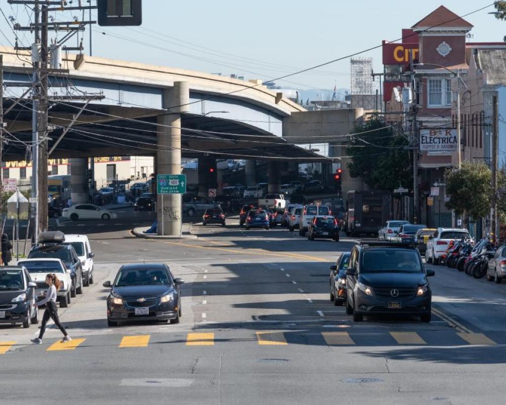 three westbound travel lanes on Duboce Avenue and the elevated Central Freeway in the background