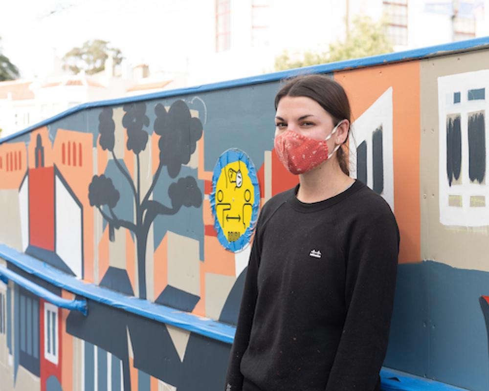 Artist Emily Fromm with her mural "East West Portal"