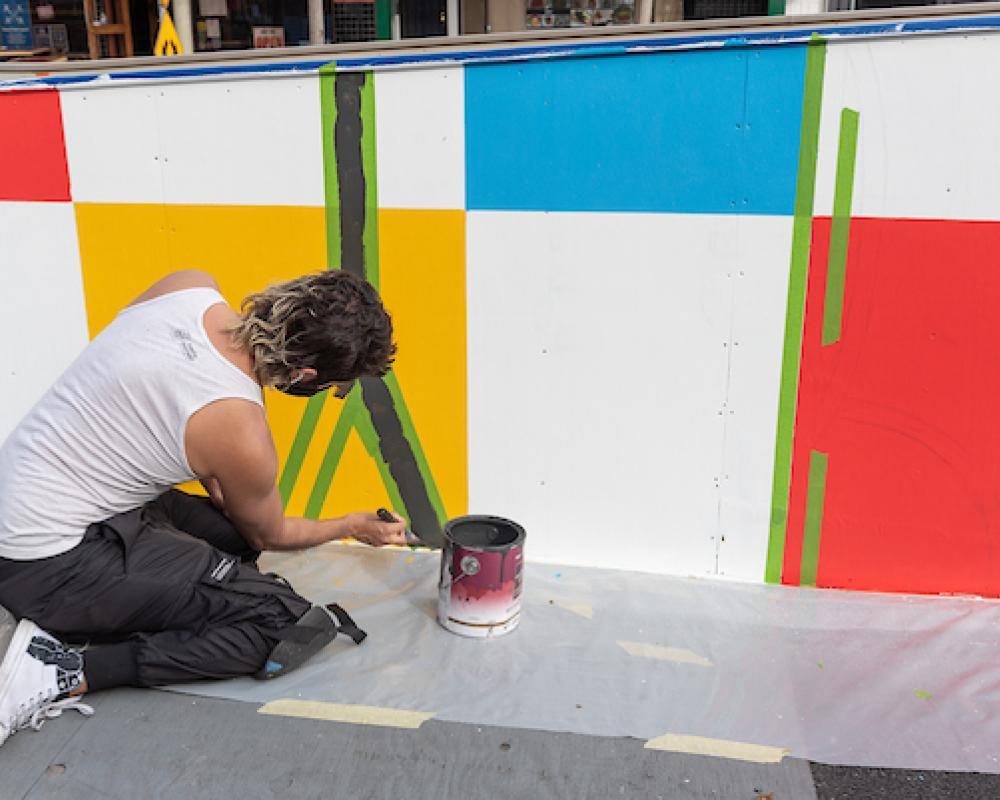 Simón Malvaez painting his mural "Them (Ramp)"