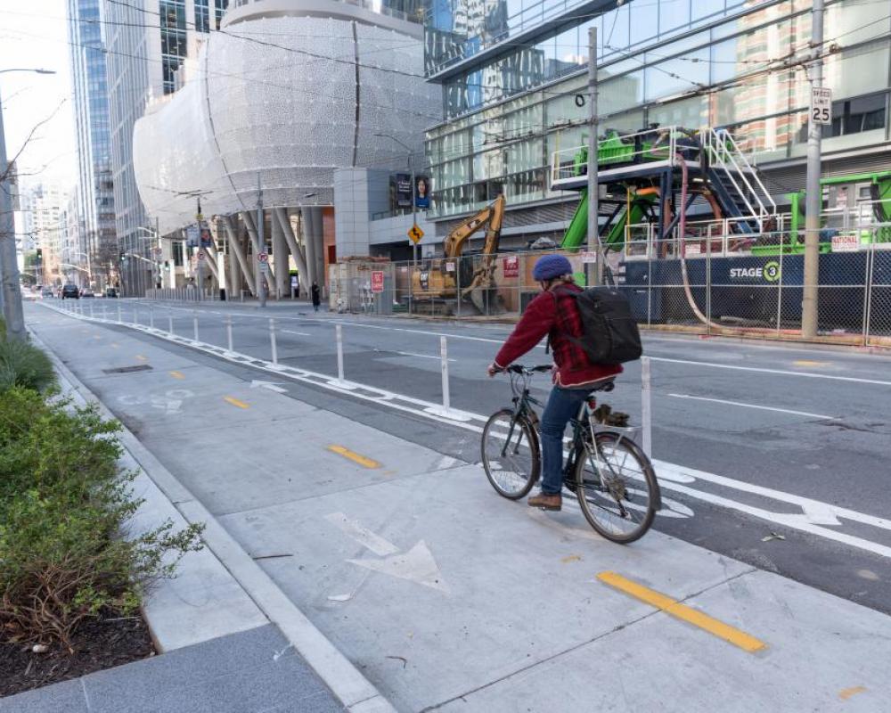 person biking in a two-way protected bikeway