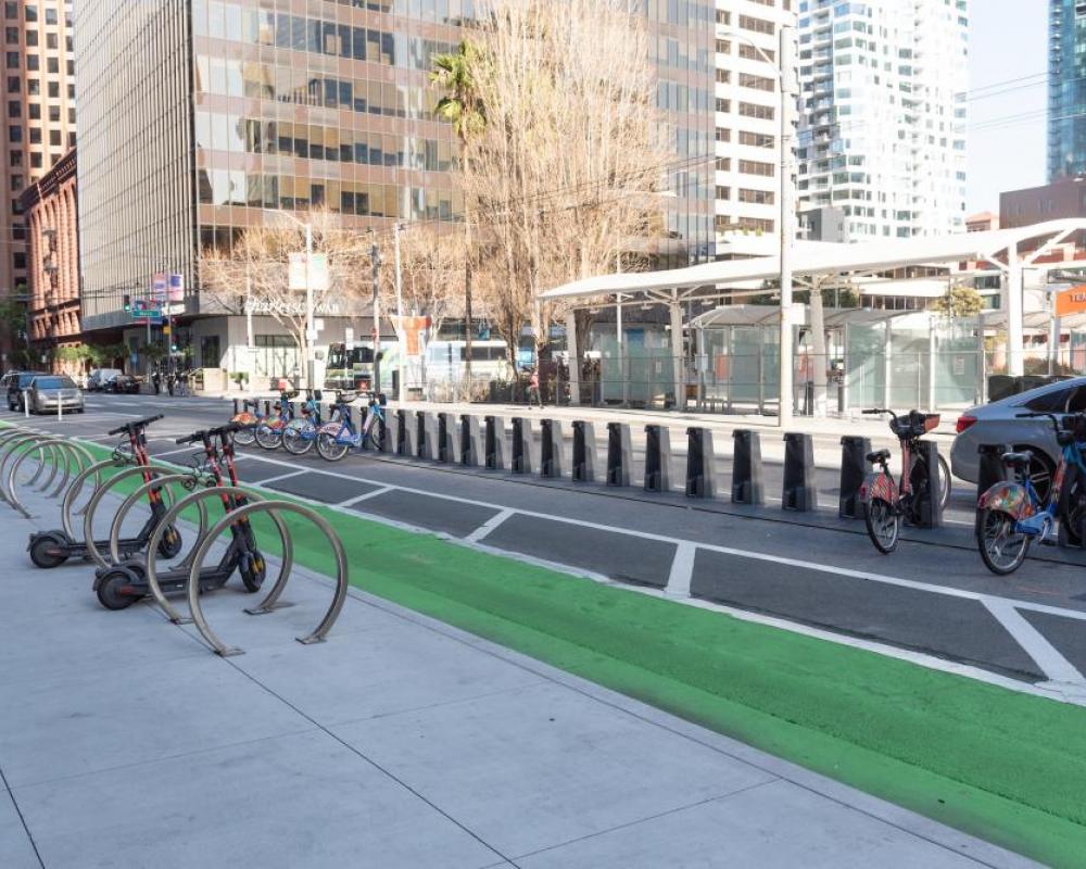 bike racks on the sidewalk, protected bikeway, and bikeshare station