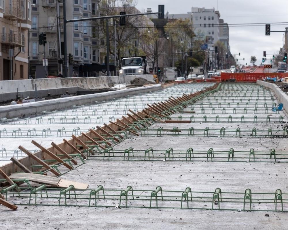 Photo of roadway under construction with cement base with rebar on Van Ness Avenue